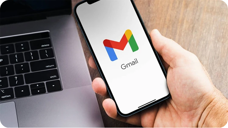 Hand holding phone with Gmail open